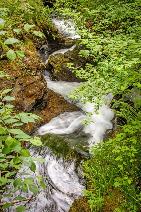 The river Lyd, in its very early stages, carves its way between rocky outcrops